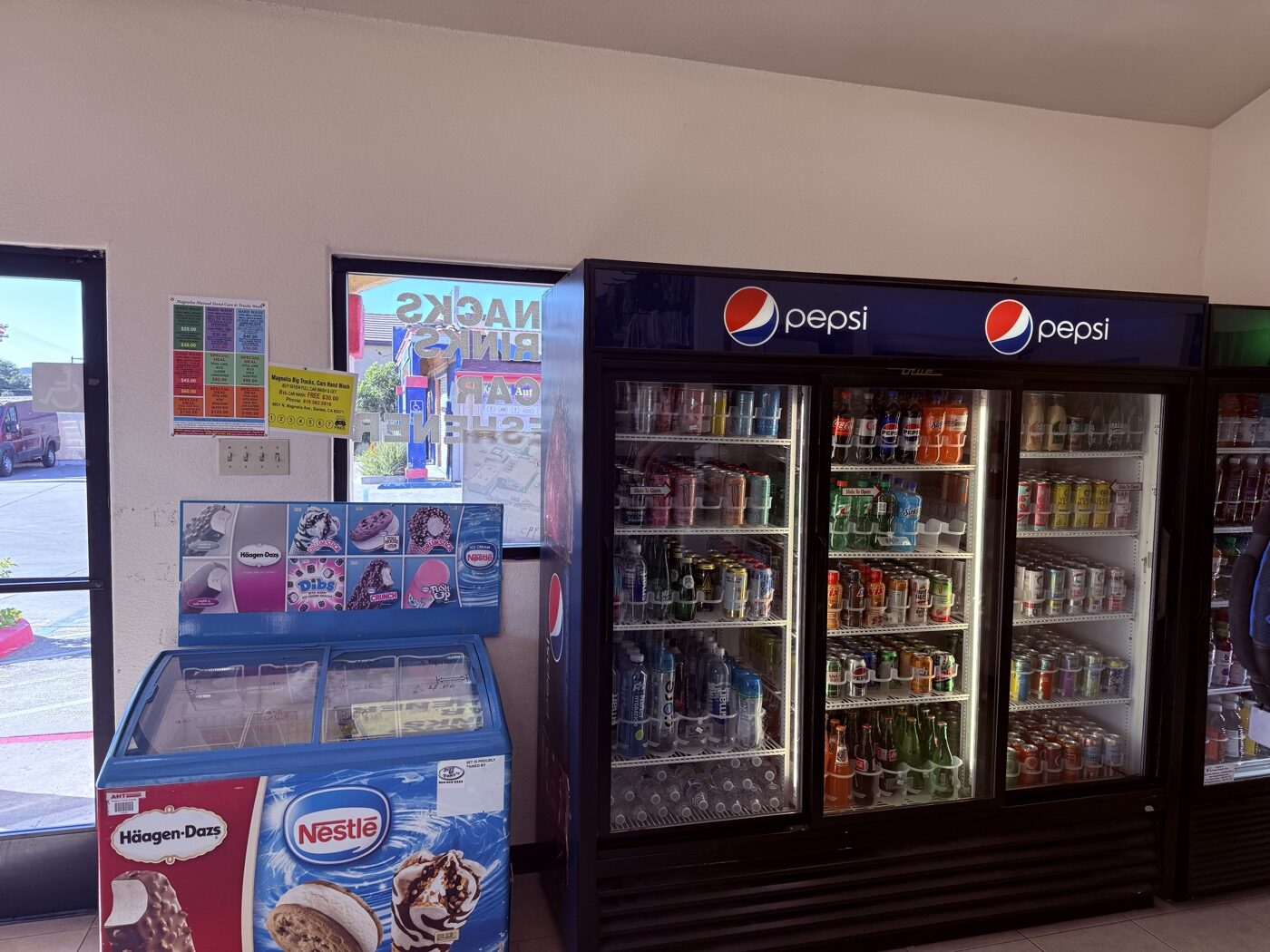 Snacks, candy and Häagen-Dazs ice cream freezer in the Magnolia Car Wash waiting room